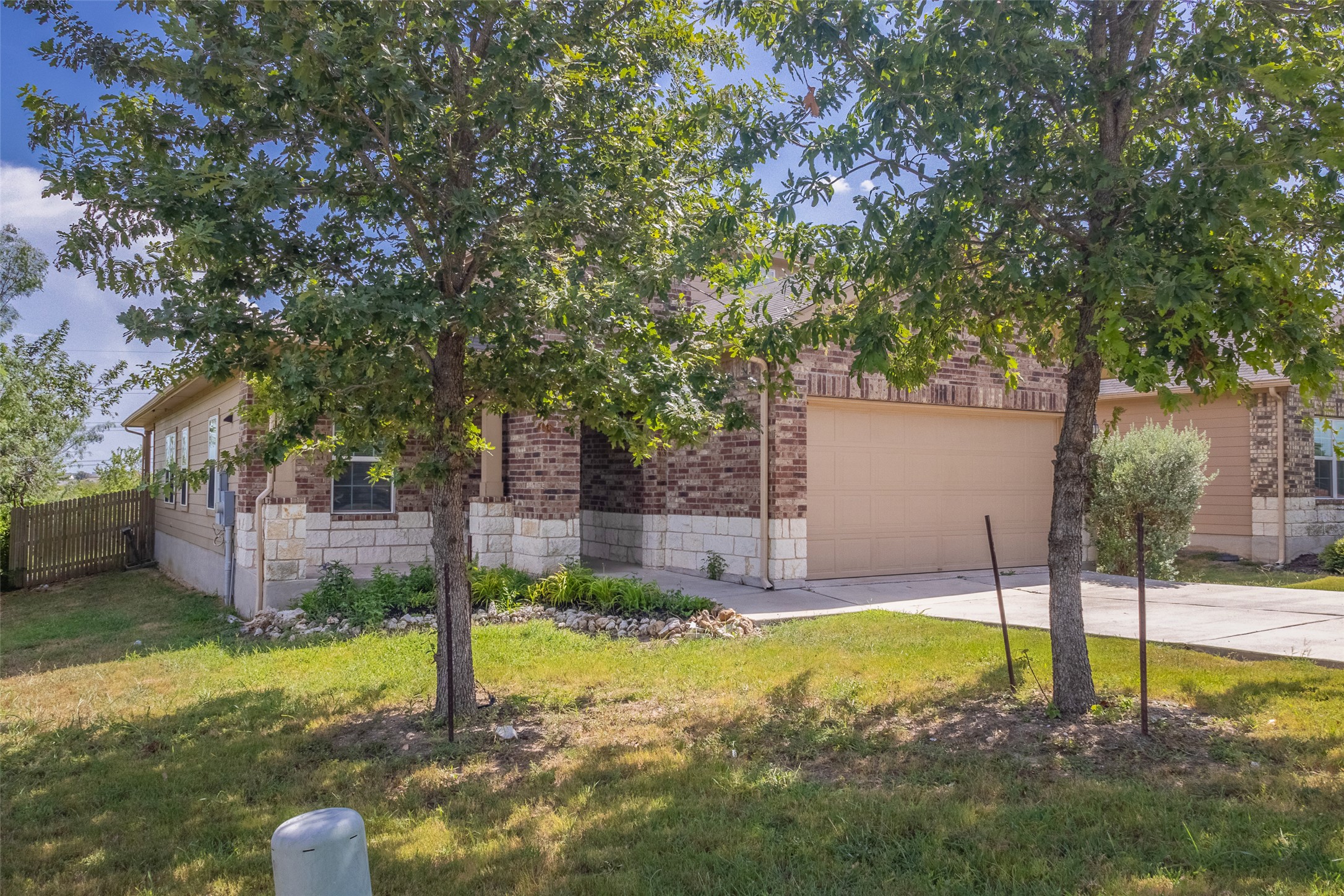 7225 Ranchito Drive Austin, TX 78744 - Photo 2 of 39 Mature trees shade this charming brick and stone home with an attached garage.