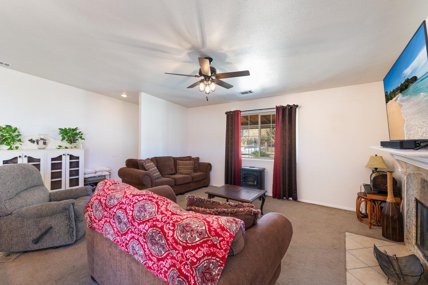 14290 Rafael Street Cabazon, CA 92230 - Photo 12 of 41 a living room with furniture and a flat screen tv