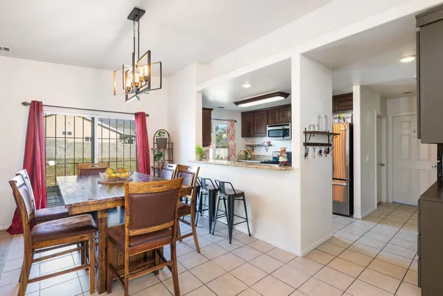 a view of a dining room and a table with chairs