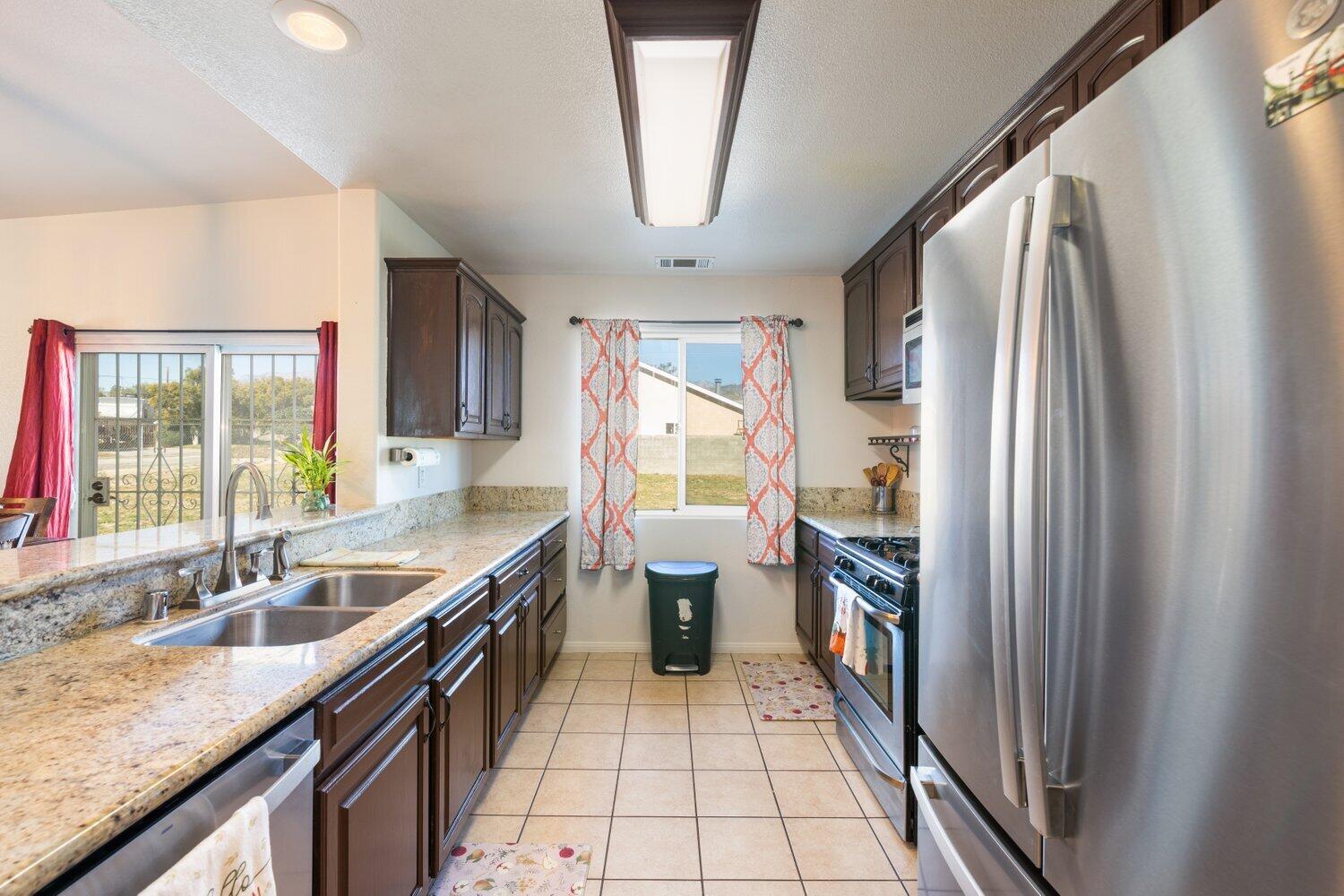 14290 Rafael Street Cabazon, CA 92230 - Photo 16 of 41 a kitchen with a sink stove and refrigerator