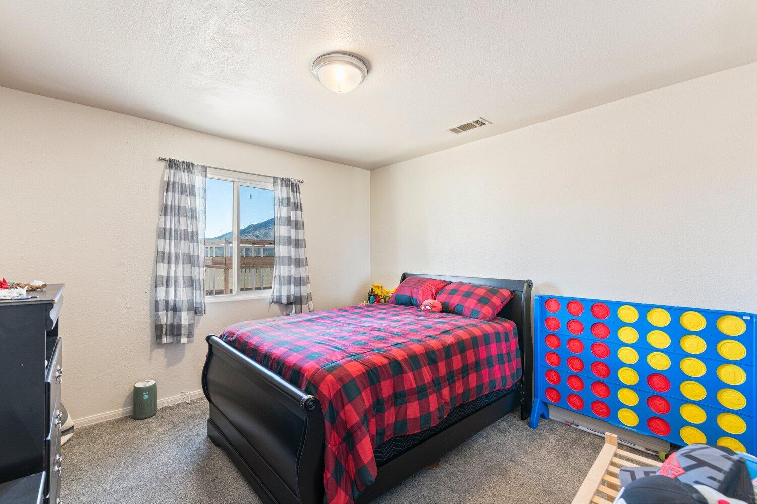 14290 Rafael Street Cabazon, CA 92230 - Photo 19 of 41 a bedroom with a bed and a window