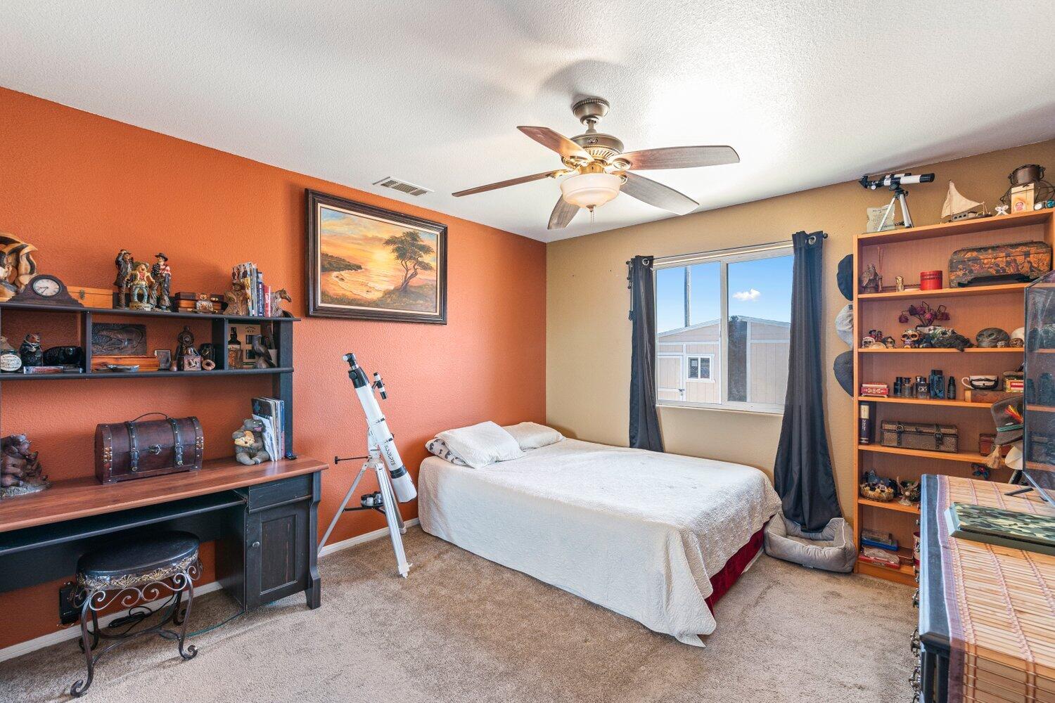 14290 Rafael Street Cabazon, CA 92230 - Photo 20 of 41 a bedroom with a bed and a bookshelf