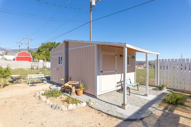 a view of a porch with a table and chairs