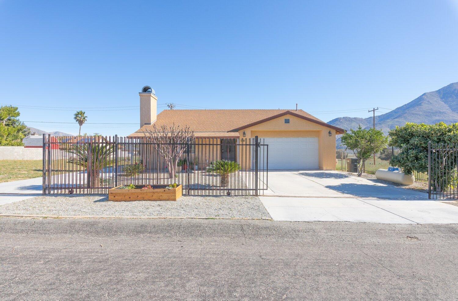 14290 Rafael Street Cabazon, CA 92230 - Photo 3 of 41 a view of a house with outdoor space and sitting area