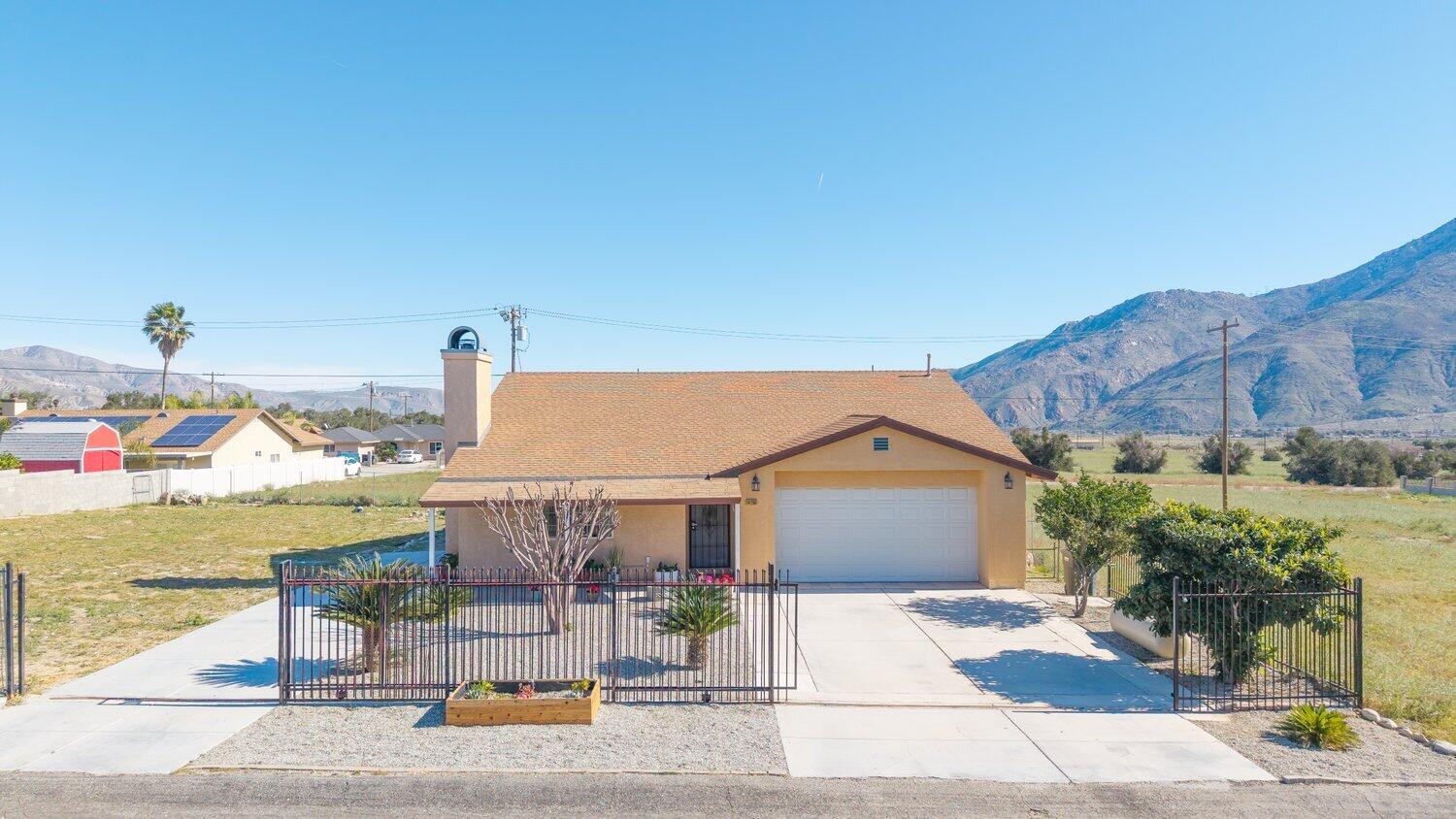 14290 Rafael Street Cabazon, CA 92230 - Photo 31 of 41 a view of a house with outdoor space and sitting area