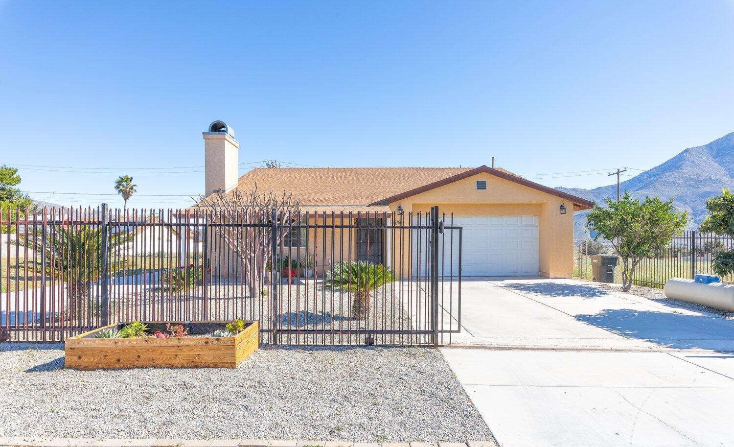 14290 Rafael Street Cabazon, CA 92230 - Photo 4 of 41 a view of a wrought iron fences in front of house