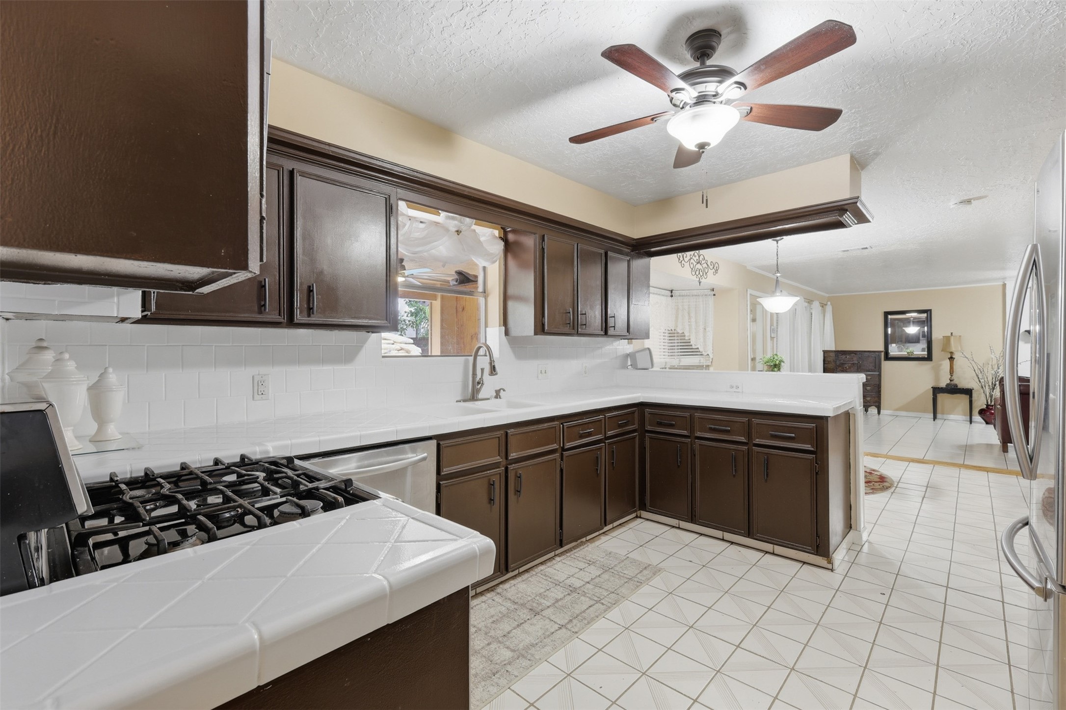 7010 River Mill Drive Spring, TX 77379 - Photo 12 of 29 a kitchen with a sink a stove and cabinets