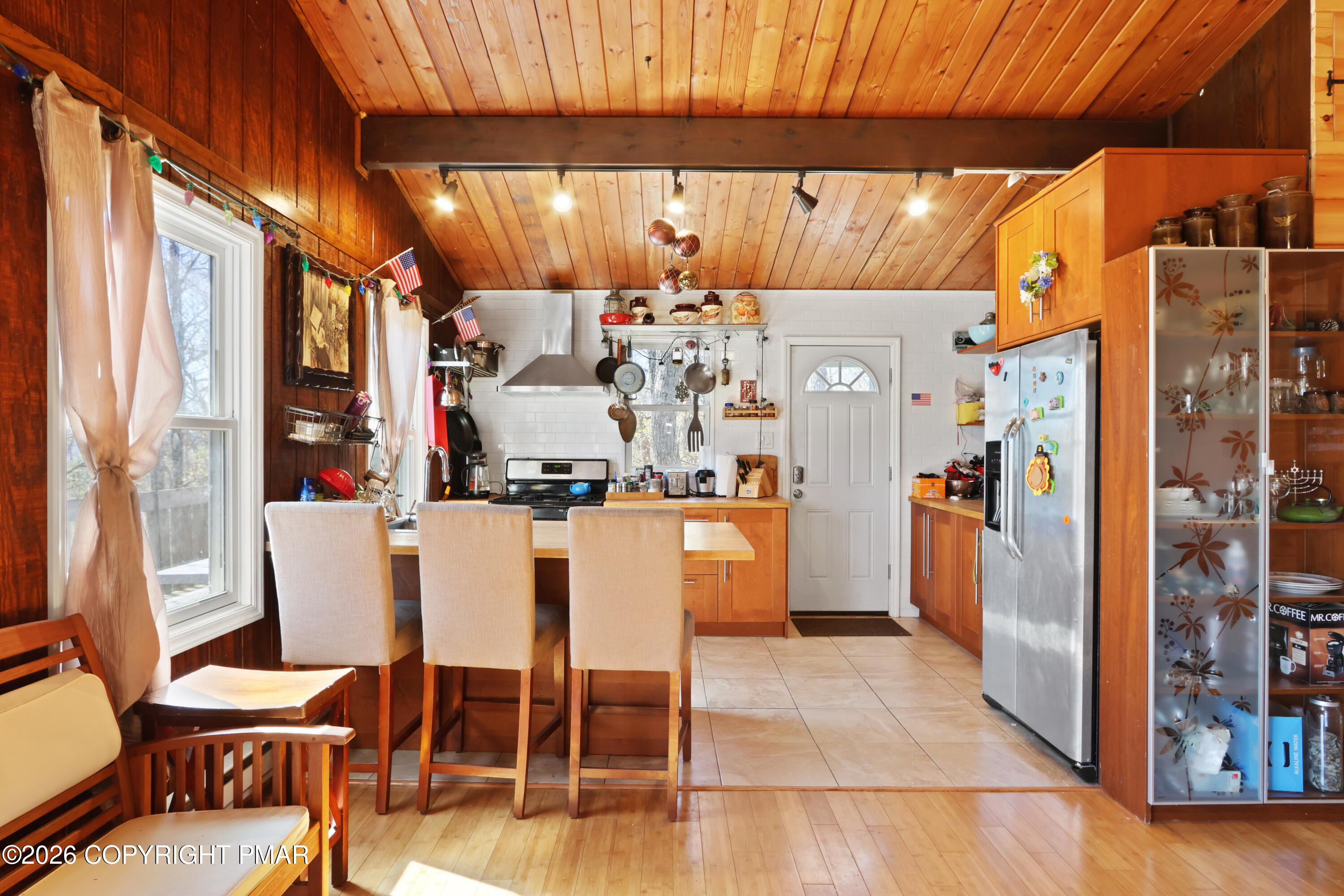 214 Mockingbird Trail Bushkill, PA 18324 - Photo 13 of 41 a kitchen with stainless steel appliances refrigerator dining table and chairs