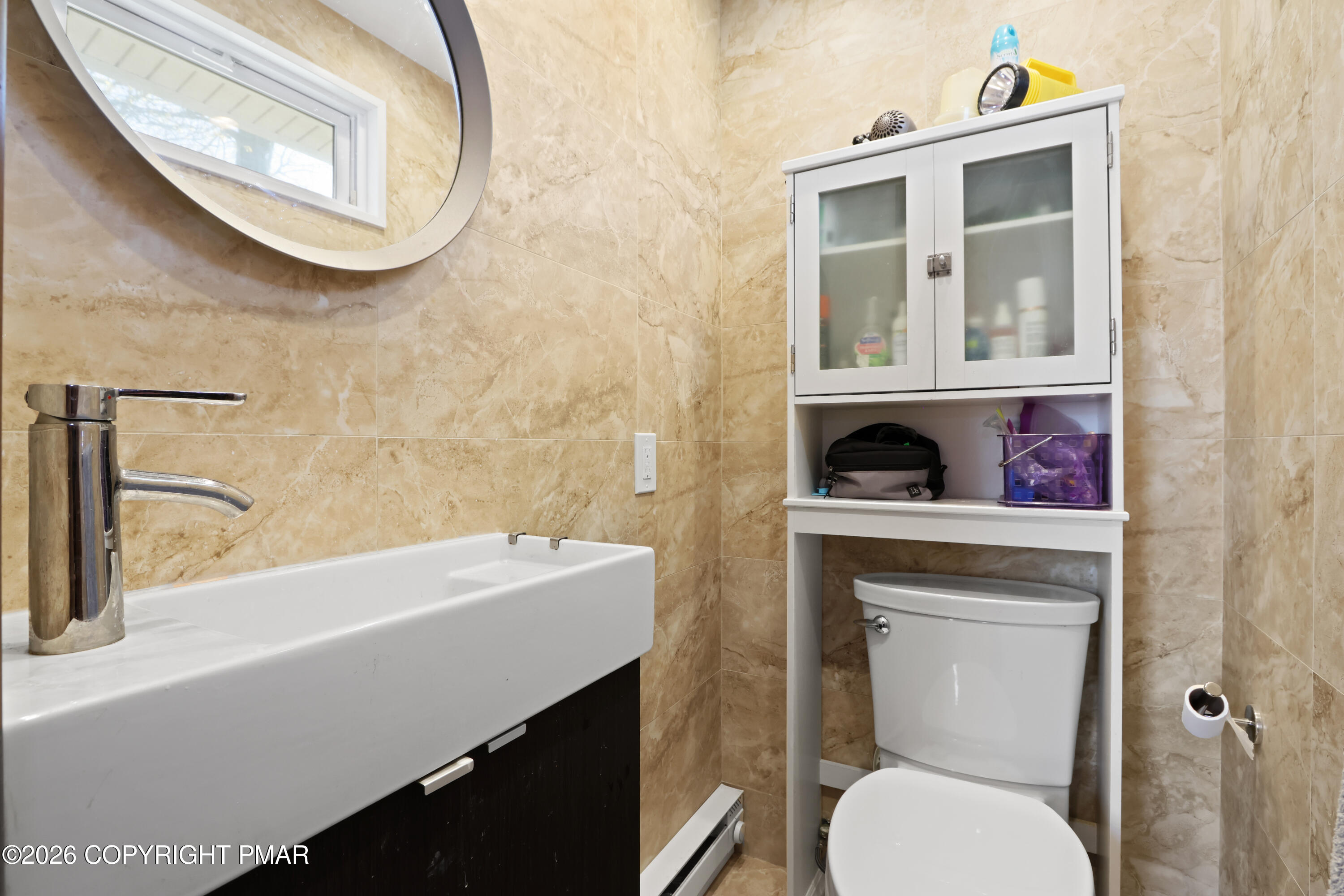 214 Mockingbird Trail Bushkill, PA 18324 - Photo 16 of 41 a bathroom with a toilet a sink and mirror