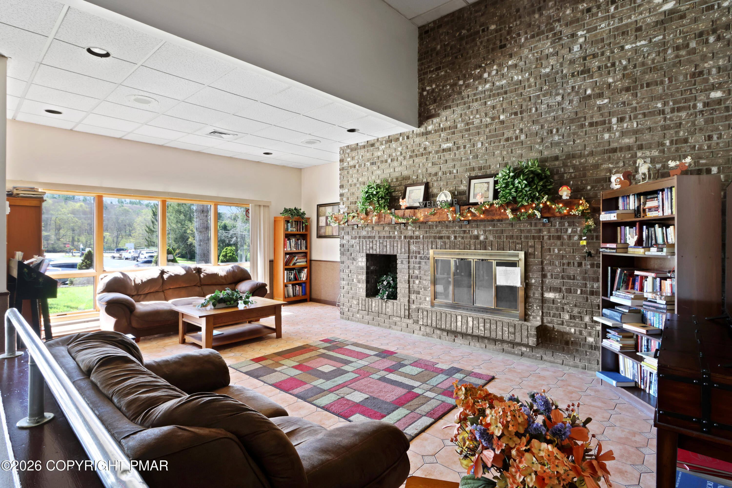 214 Mockingbird Trail Bushkill, PA 18324 - Photo 29 of 41 a living room with furniture a rug and a fireplace