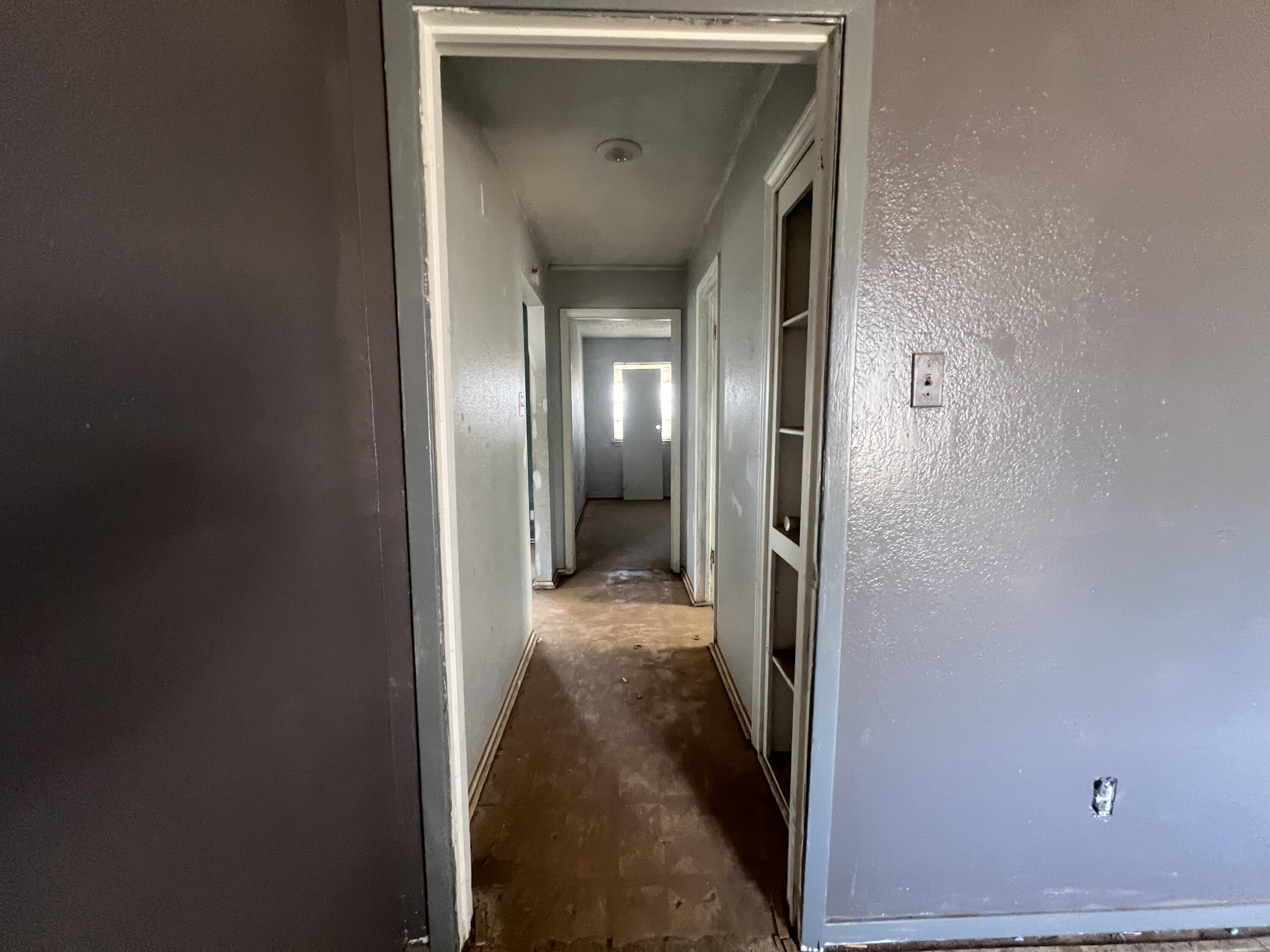 1309 32nd Street Lubbock, TX 79411 - Photo 12 of 28 a view of a hallway with wooden floor and a living room
