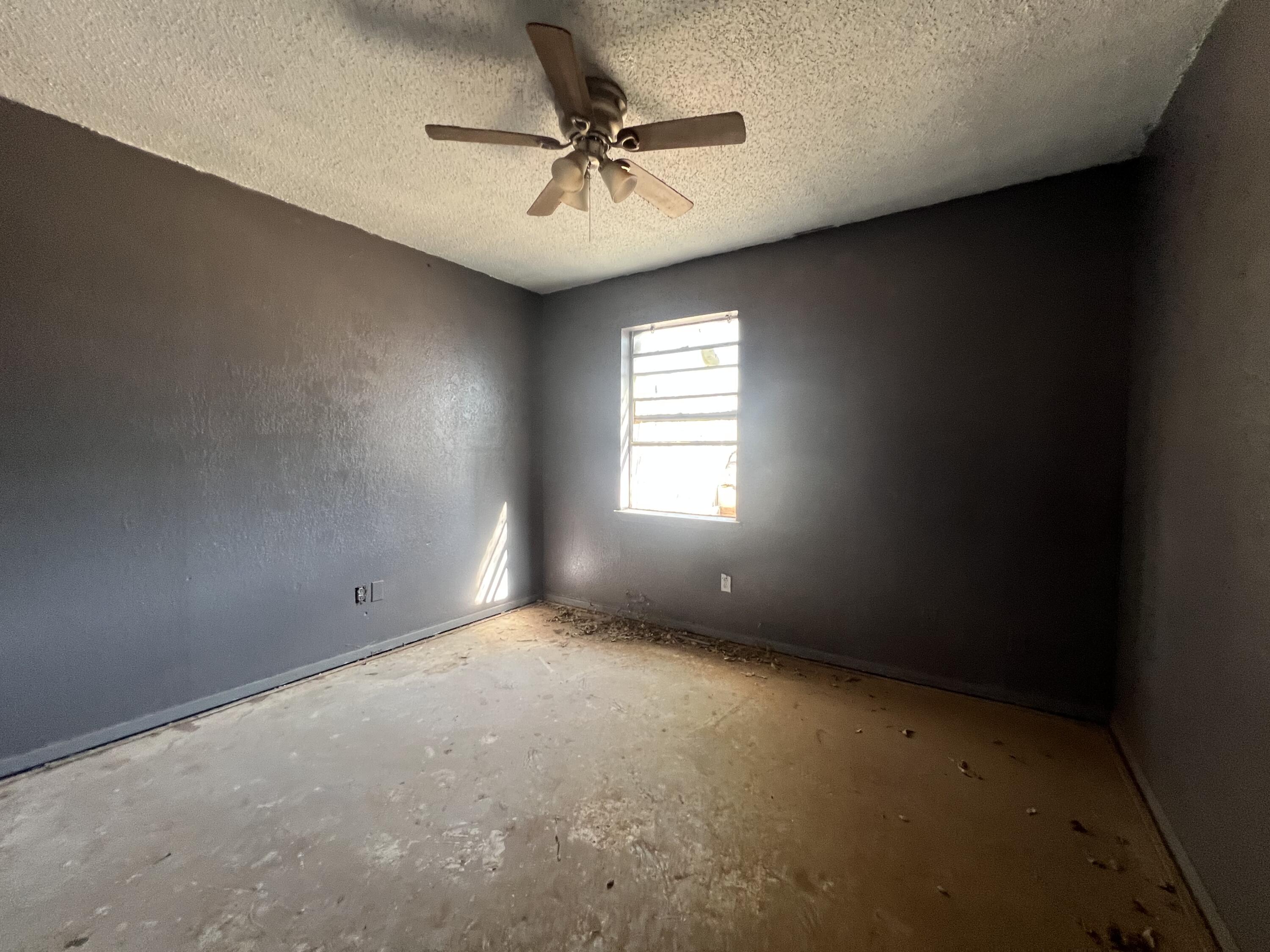 1309 32nd Street Lubbock, TX 79411 - Photo 14 of 28 an empty room with a window and a fan