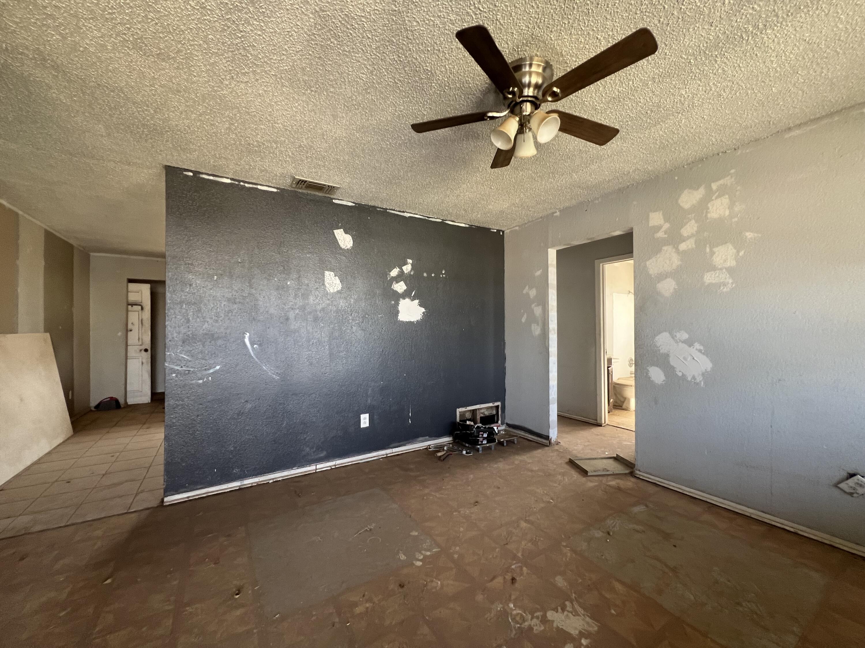 1309 32nd Street Lubbock, TX 79411 - Photo 6 of 28 a view of a livingroom with a ceiling fan and window