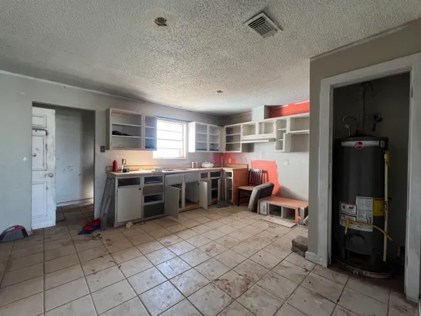a kitchen with a sink and a refrigerator