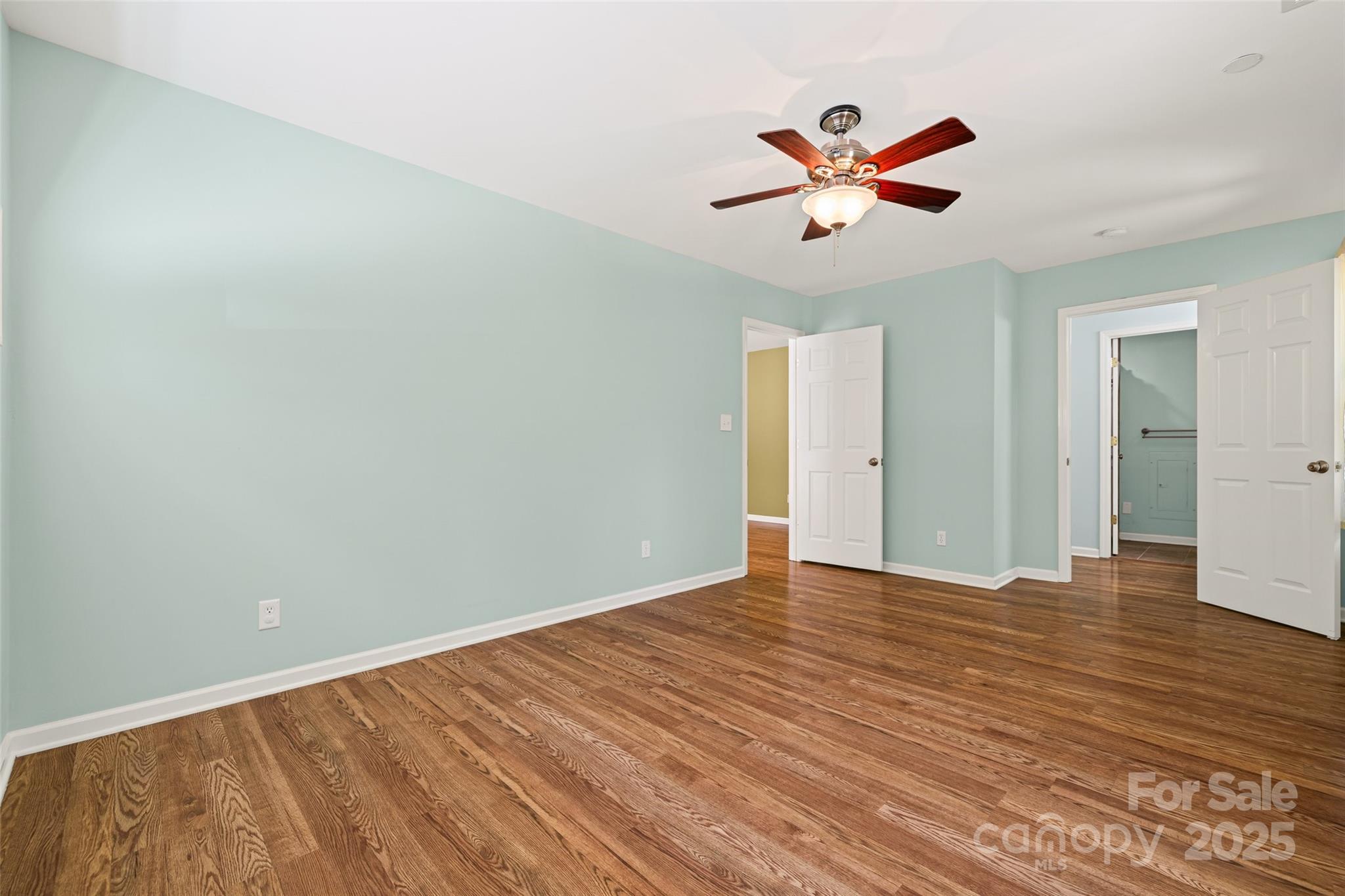 229 Campsite Road Rock Hill, SC 29732 - Photo 22 of 45 a view of an empty room with wooden floor and a ceiling fan