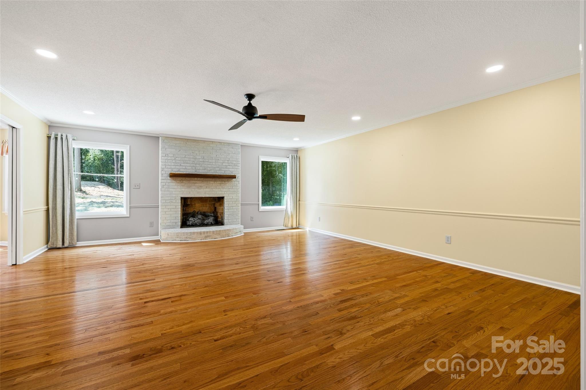 229 Campsite Road Rock Hill, SC 29732 - Photo 9 of 45 a view of empty room with wooden floor and fireplace