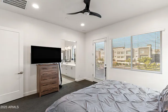 a bedroom with a bed and a flat screen tv