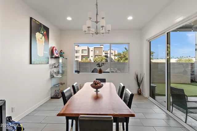 a view of a dining room with furniture and a chandelier