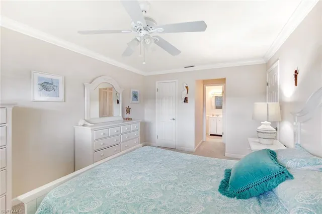 a spacious bedroom with a bed and a chandelier