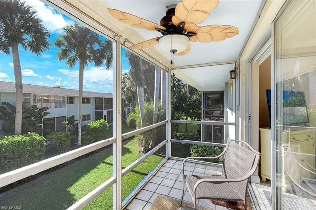 a view of a chair and tables in the balcony