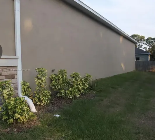 a backyard of a house with lots of green space and plants
