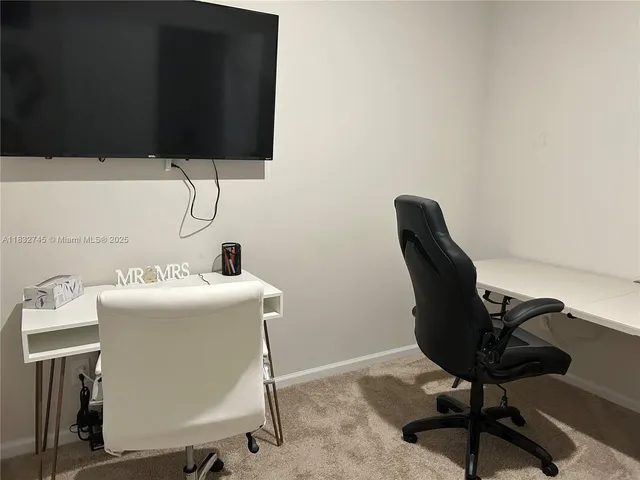 a workspace with furniture and screen