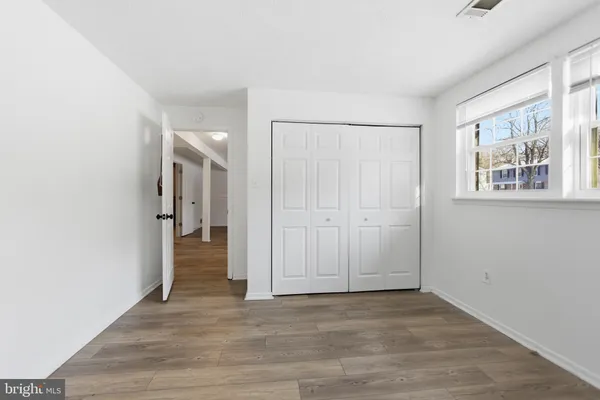 an empty room with wooden floor and a window