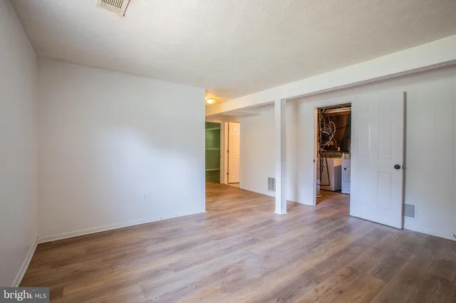 a view of a livingroom with wooden floor and closet