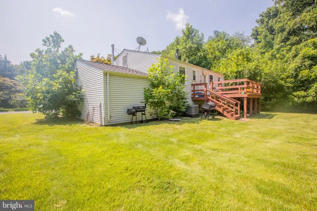 a house view with swimming pool in front of it