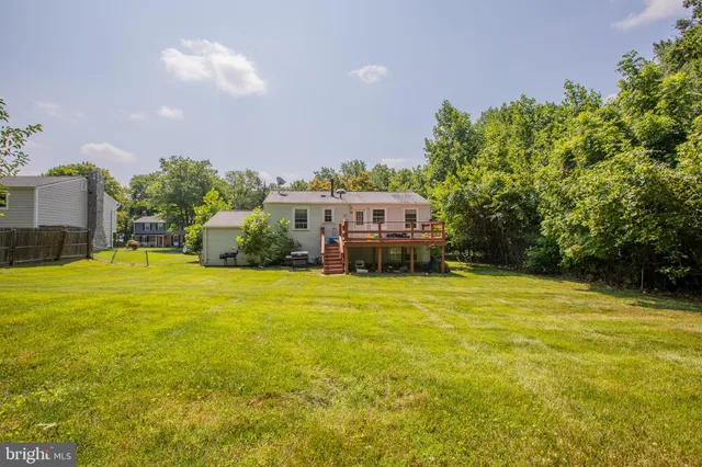 a view of a house with pool and chairs