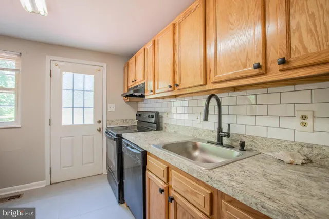 a kitchen with granite countertop a sink and a window