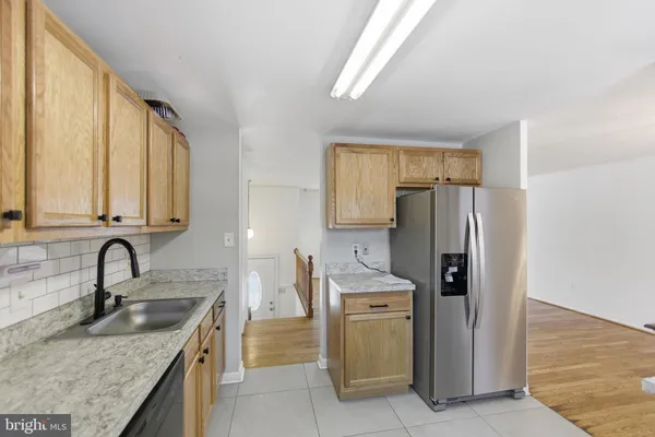 a kitchen with refrigerator and cabinets