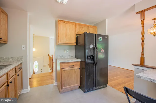 a kitchen with stainless steel appliances granite countertop a refrigerator and a stove