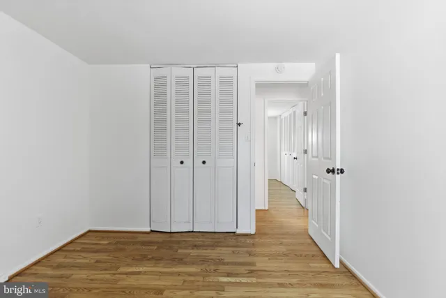 a view of a bathroom with wooden floor and a bathroom