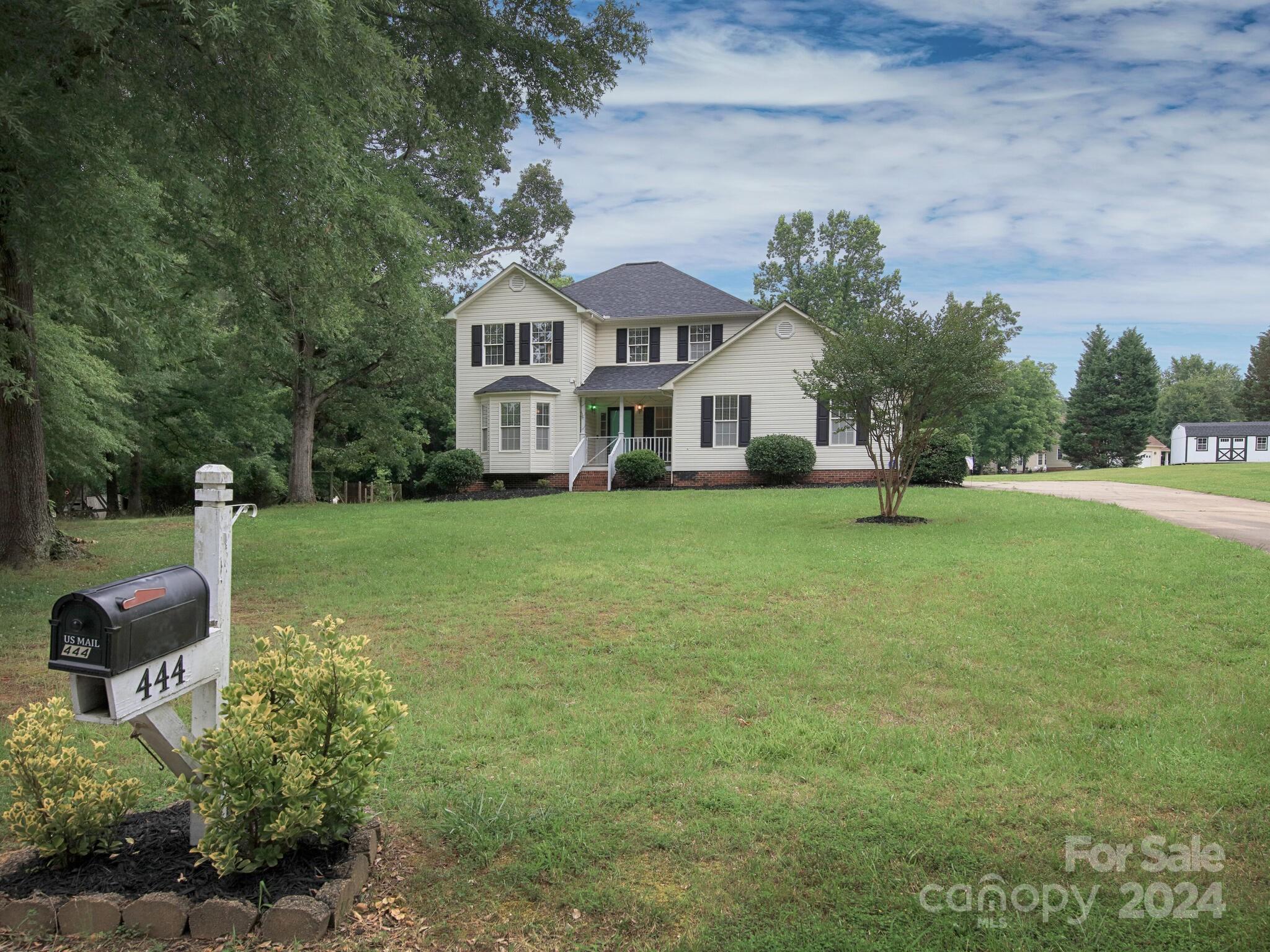 444 Cress Loop Road Salisbury, NC 28147 - Photo 3 of 27 a view of a white house with a big yard and large trees