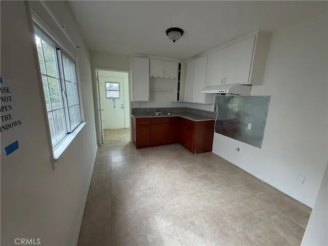 a large kitchen with a window