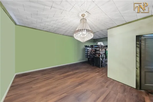 a view of a room with wooden floor water heater and a window