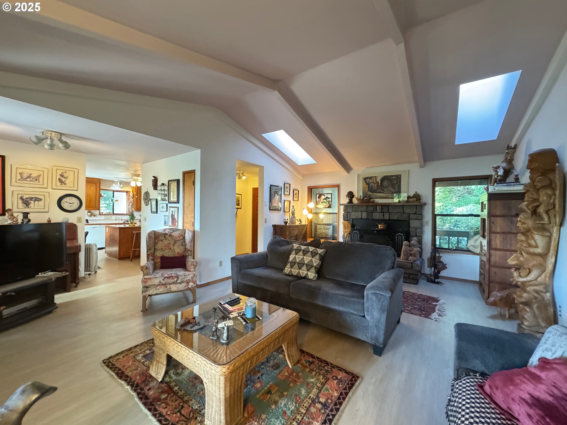 88468 Trout Pond Lane Southwest Bandon, OR 97411 - Photo 11 of 44 a living room with furniture and a fireplace
