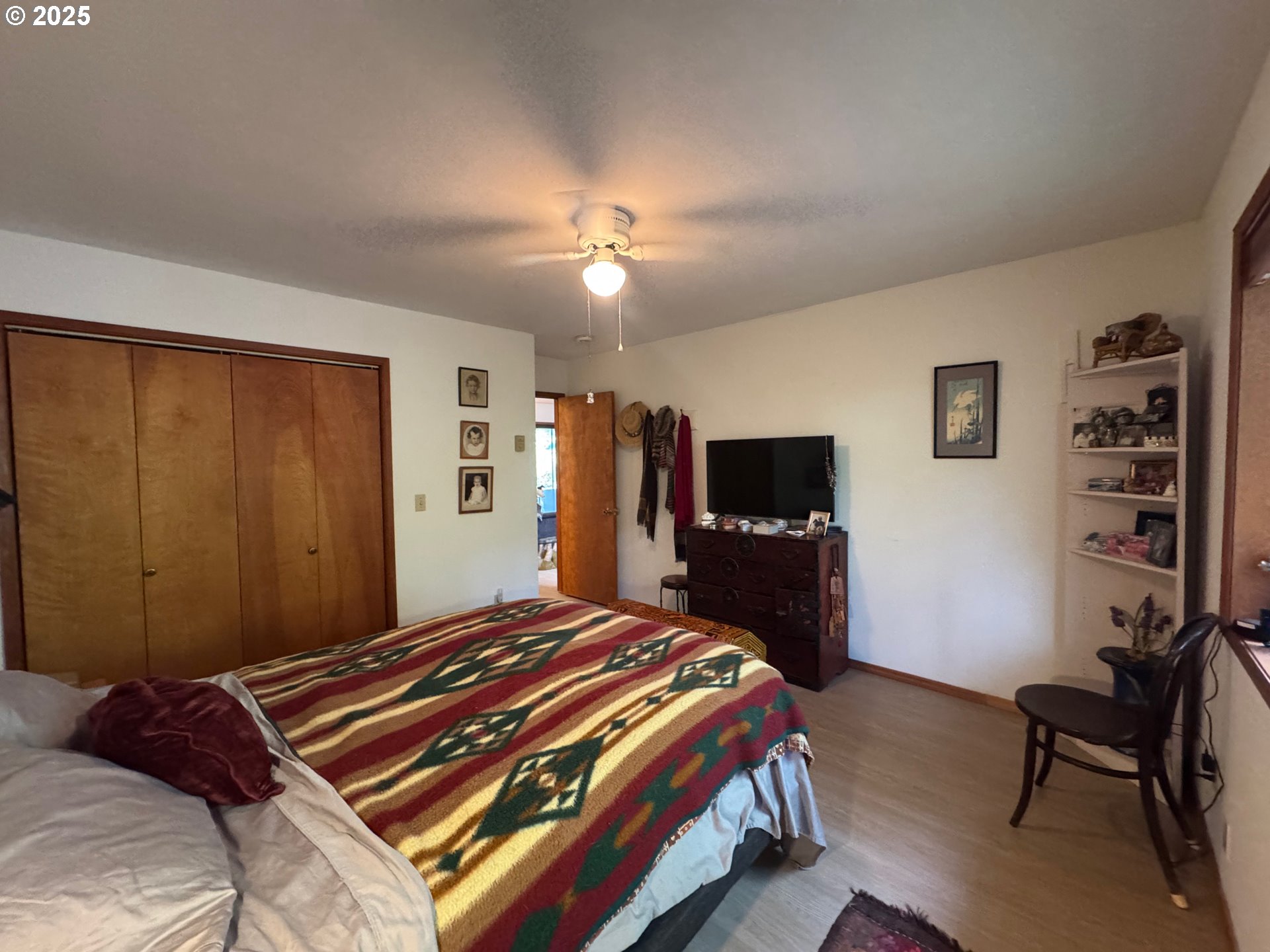 88468 Trout Pond Lane Southwest Bandon, OR 97411 - Photo 14 of 44 a bedroom with a bed and a flat screen tv