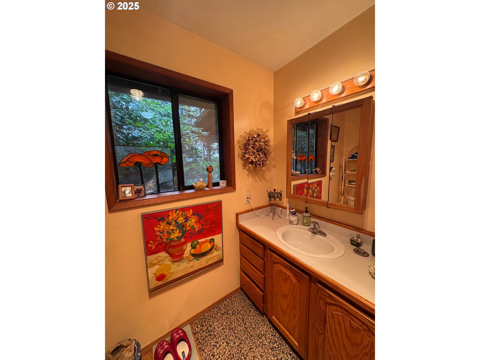 88468 Trout Pond Lane Southwest Bandon, OR 97411 - Photo 15 of 44 a bathroom with a sink and a large mirror