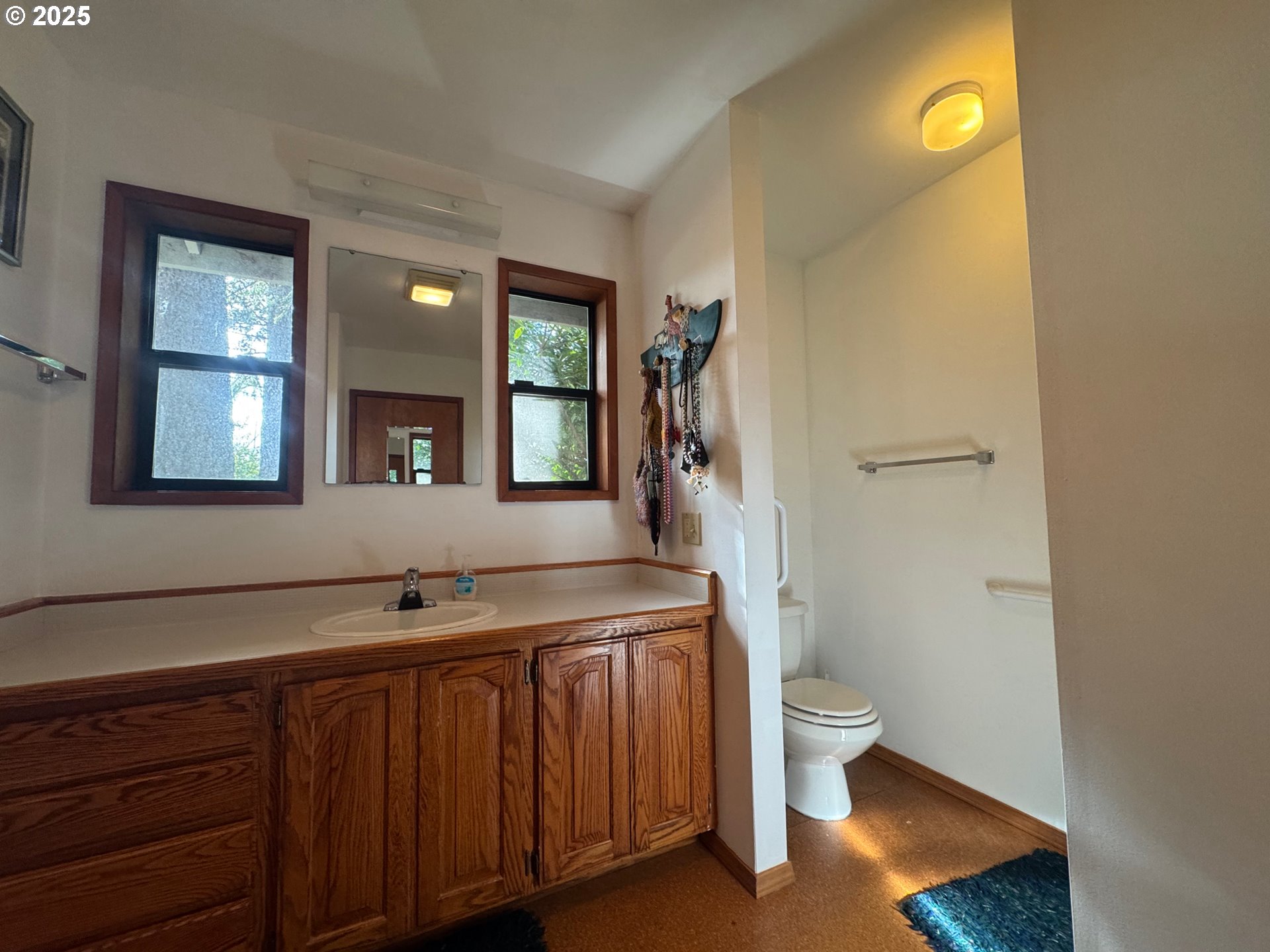 88468 Trout Pond Lane Southwest Bandon, OR 97411 - Photo 21 of 44 a bathroom with a sink a toilet and shower