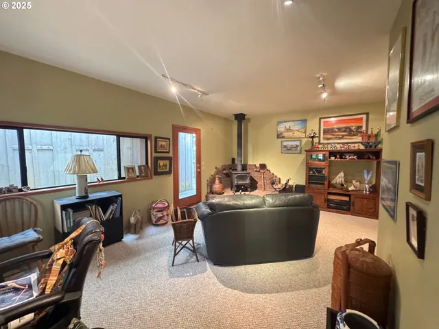 a living room with furniture flat screen tv and a large window