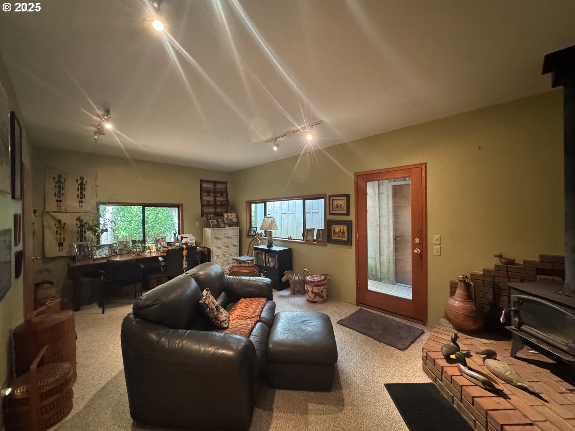 88468 Trout Pond Lane Southwest Bandon, OR 97411 - Photo 25 of 44 a living room with furniture flat screen tv and a large window