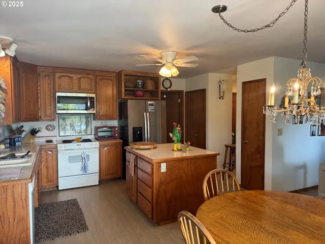 a kitchen that has a lot of cabinets in it and stainless steel appliances