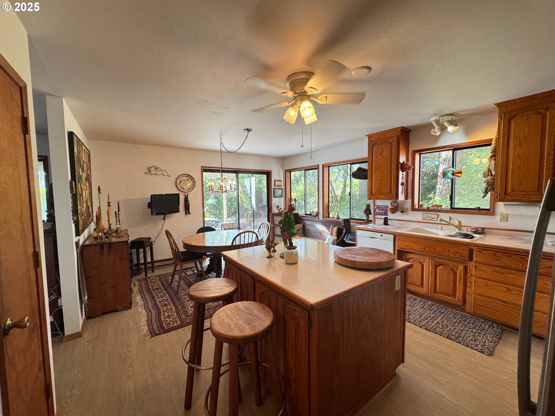 88468 Trout Pond Lane Southwest Bandon, OR 97411 - Photo 7 of 44 a large kitchen with a table and chairs