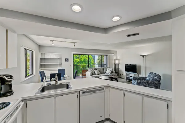a kitchen with a sink appliances and a counter top space