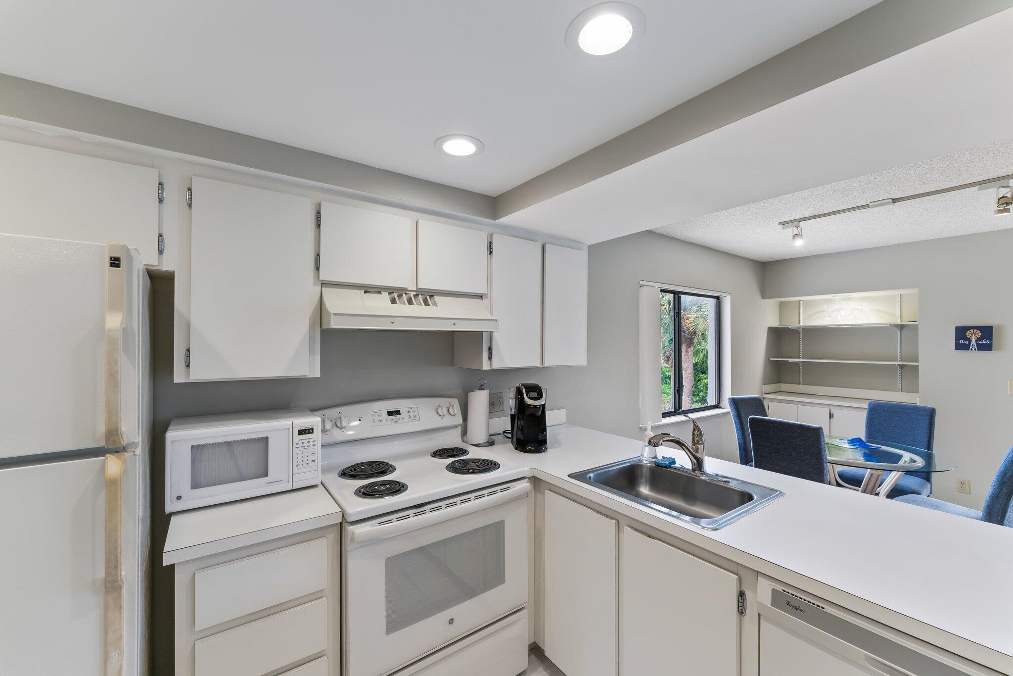 1605 Highway 1, Unit D301 Jupiter, FL 33477 - Photo 18 of 29 a kitchen with a sink a stove and refrigerator