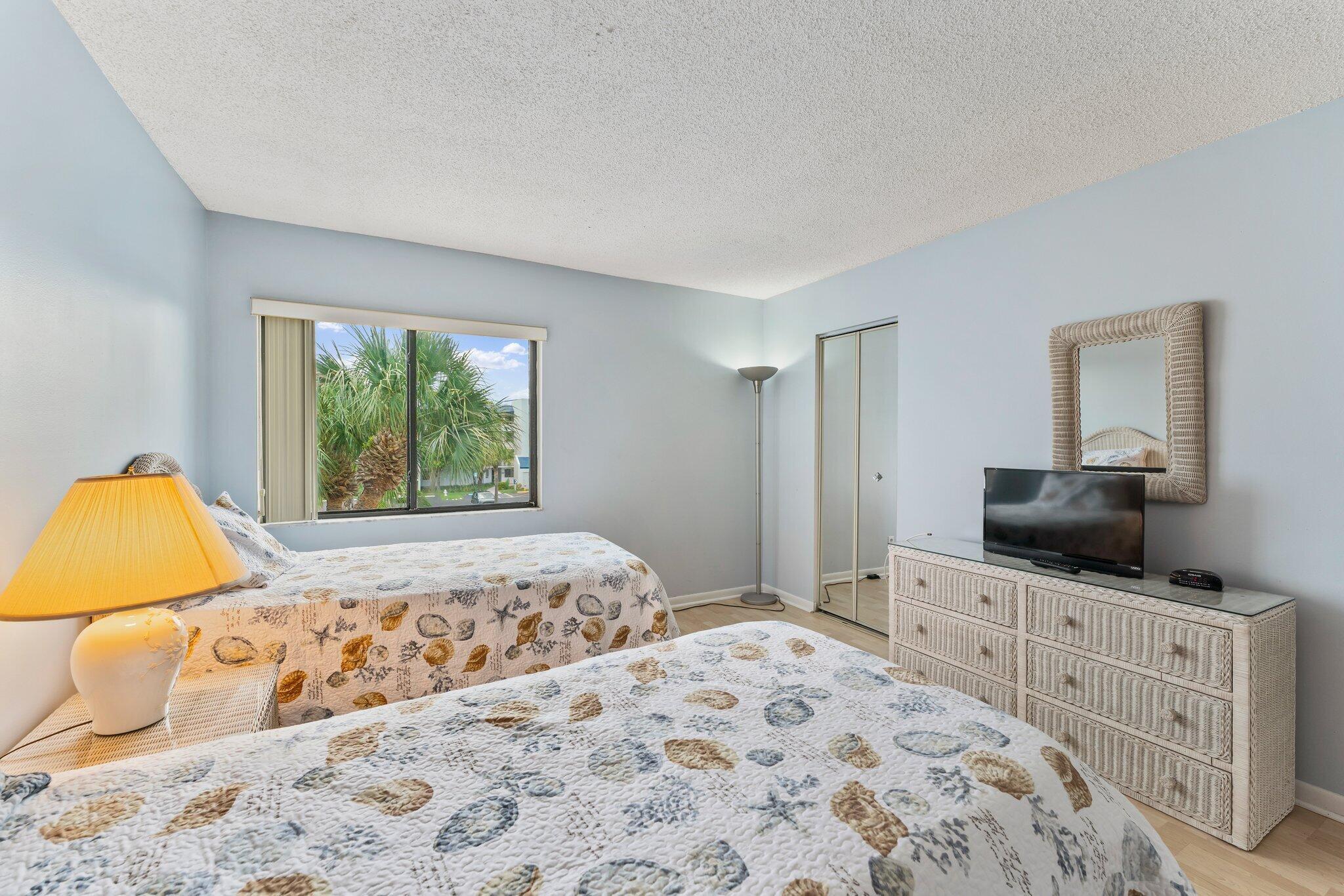 1605 Highway 1, Unit D301 Jupiter, FL 33477 - Photo 21 of 29 a bedroom with a bed and a flat screen tv
