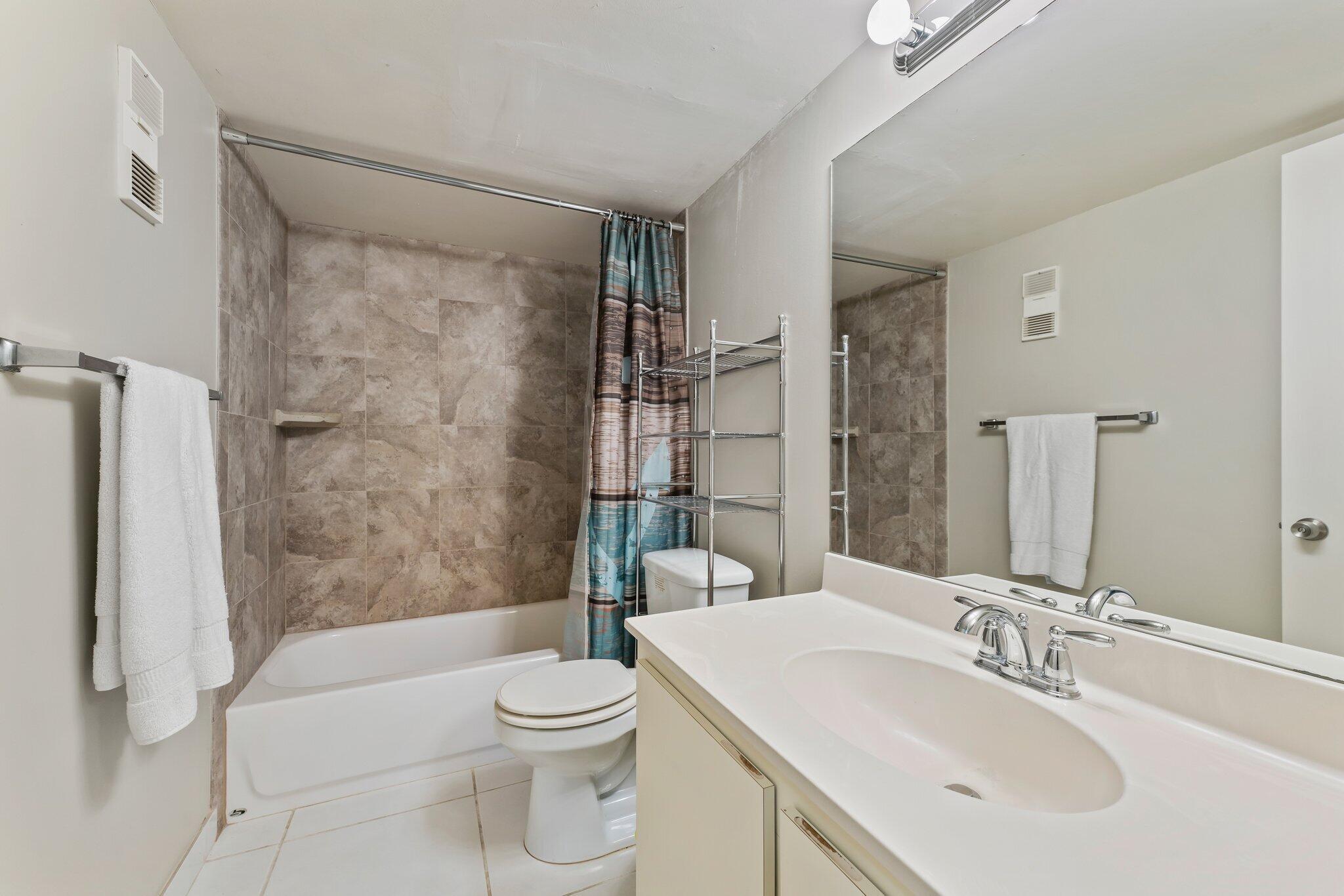 1605 Highway 1, Unit D301 Jupiter, FL 33477 - Photo 22 of 29 a bathroom with a sink toilet and shower