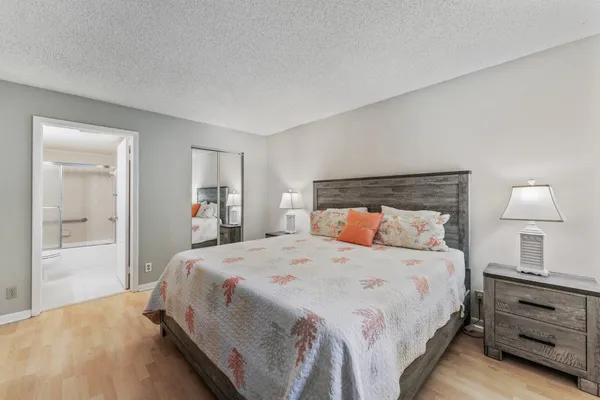 a bedroom with a bed and a lamp